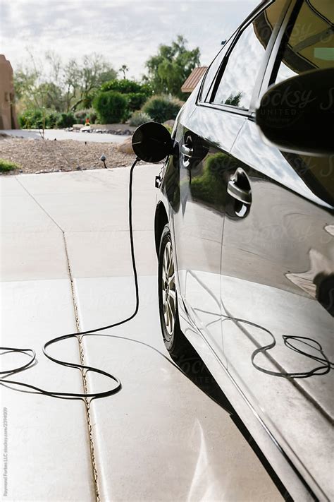 "Electric Car Charging Cable" by Stocksy Contributor "Raymond Forbes ...