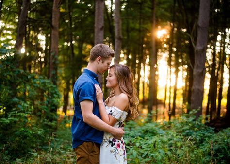 Couple holding each other close in the middle of the woods. During golden hour. sunset. as the ...