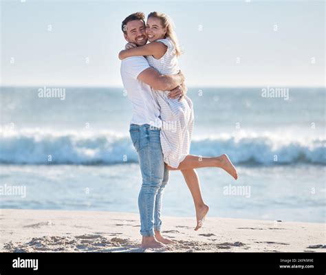 Hug, happy and couple at the beach for love, peace and relax on a ...