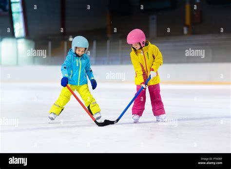 Children play ice hockey on indoor rink. Healthy winter sport for kids ...