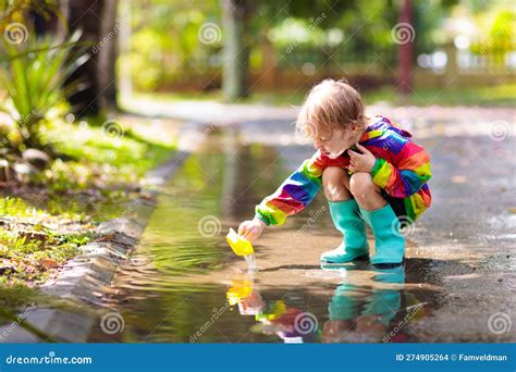 Kids in Puddle in Autumn Rain. Waterproof Wear Stock Photo - Image of ...