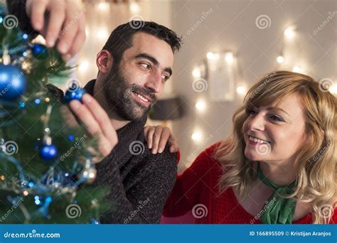 Smiling Friends Decorating Tree for Christmas in Living Room. Holidays ...