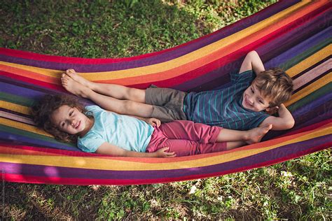 Children Relaxing On A Hammock by Dejan Ristovski