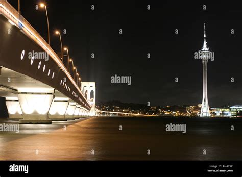 Macau tower and Macau Bridge by night Stock Photo - Alamy