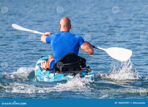 Young Kayaker Paddling Kayak. Sportsman Kayaking Blue Water Stock Image ...