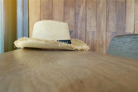 Beige and Black Straw Hat on Wooden Surface · Free Stock Photo