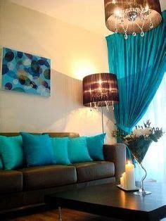 the living room is decorated in teal and brown