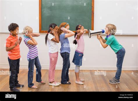 Cute pupil shouting in classroom Stock Photo - Alamy