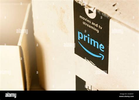 Rome, Italy, August 2020: The Amazon Prime logo printed on the black safety tape on a cardboard ...