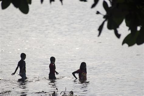 Sorong, Indonesia 2021- People on the beach 3363887 Stock Photo at Vecteezy