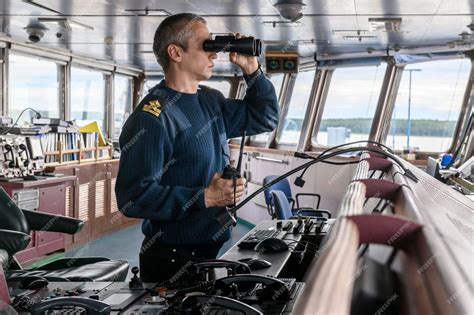 Premium Photo | Deck officer with binoculars on navigational bridge seaman on board of vessel ...