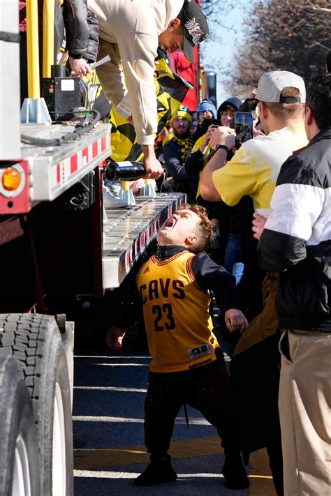 Columbus Crew fans have drinks poured from the float during a parade celebrating their 2023 MLS ...