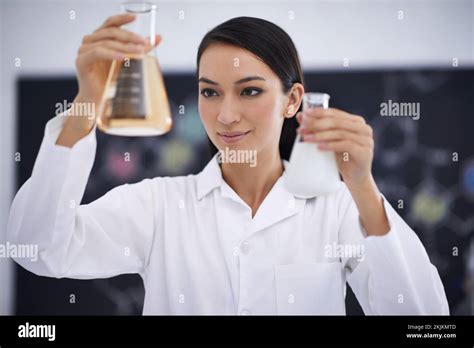 Which beaker is the right one. a female scientist observing liquids in conical beakers Stock ...