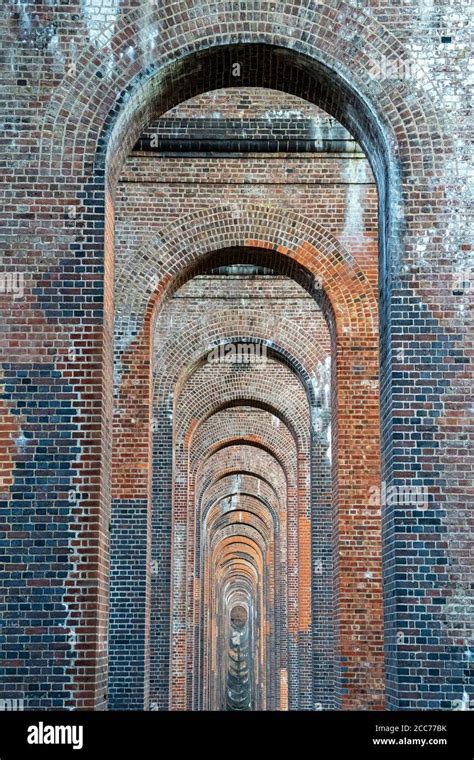 View through the arches of the Ouse Valley Viaduct (Balcombe Viaduct) carrying the London to ...