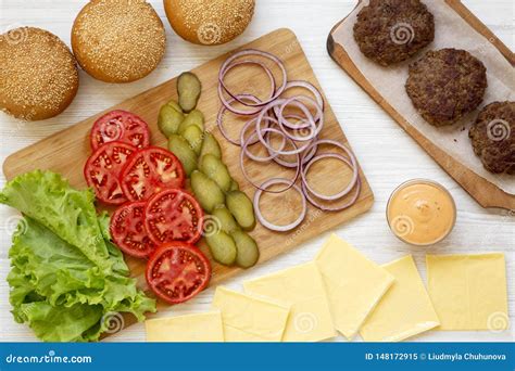 Cheeseburger Ingredients on a White Wooden Background, Top View. Flat ...