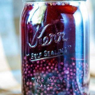 a jar filled with liquid sitting on top of a table