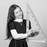 Kid school uniform hold ruler. Pupil cute girl with big ruler. Geometry school subject ...