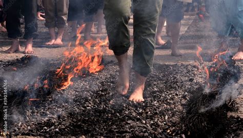 feet of people walking on hot coals Stock Photo | Adobe Stock