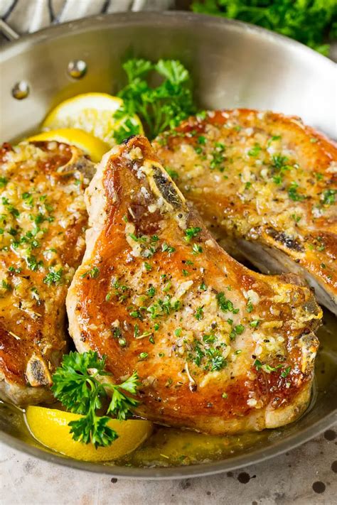 These baked pork chops are coated in garlic and herb butter, then oven roasted to golden brown ...