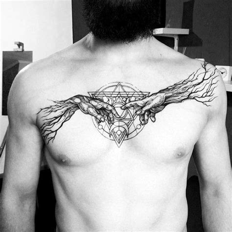 a man's chest with an artistic tattoo on it