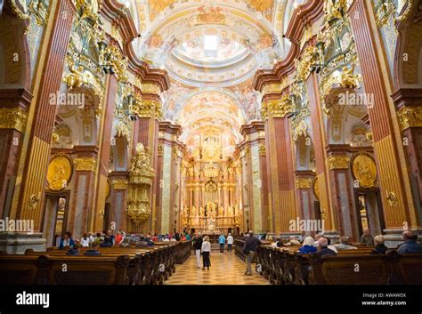 Visitors in the abbey church inside the baroque benedictine monastery ...