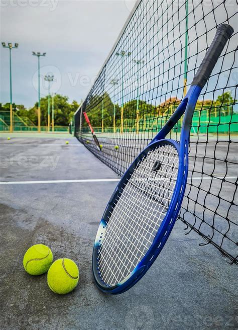 Tennis racket and tennis balls on tennis hard court. 11046703 Stock Photo at Vecteezy