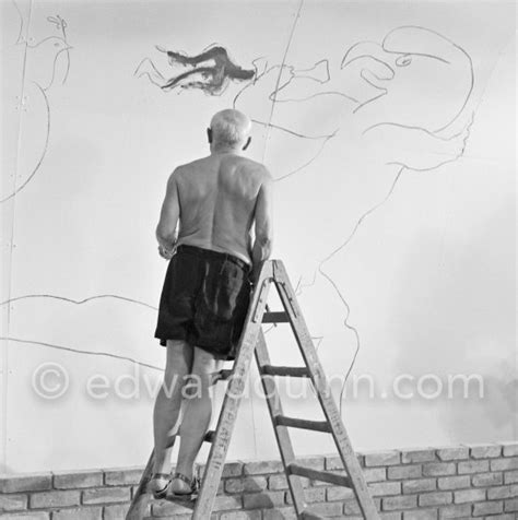 Pablo Picasso working on the "War and Peace study" drawings on the wall ...