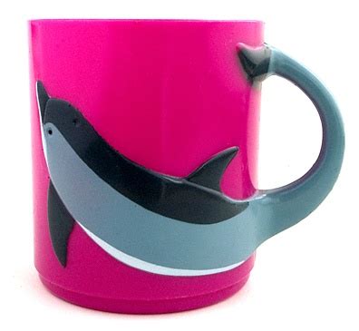 a pink and grey coffee mug with a dolphin on the bottom, sitting in front of a white background