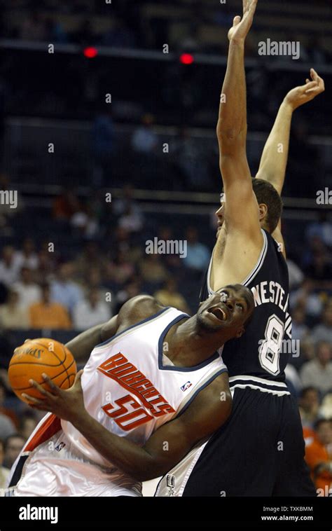 Charlotte Bobcats center Emeka Okafor looks for room to shoot around San Antonio Spurs center ...