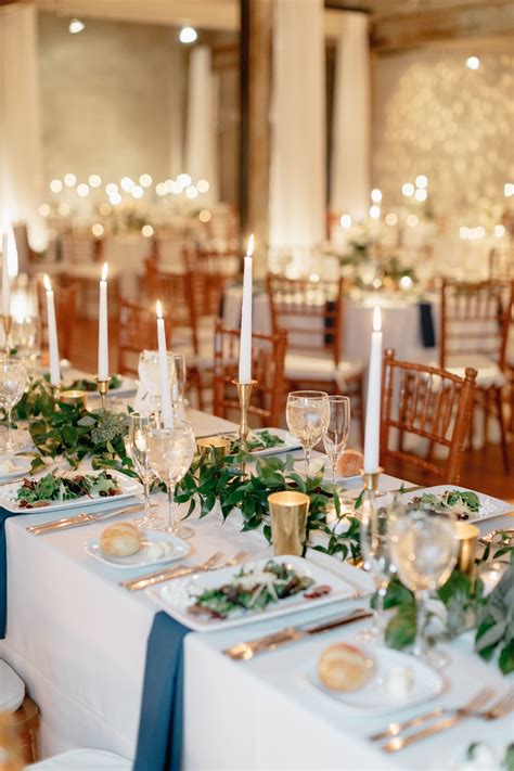 Long table centerpiece with greenery and candles. Photo by Emily Wren Photography https ...