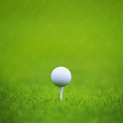 Premium Photo | Golf ball on tee on green grass of golf course ...