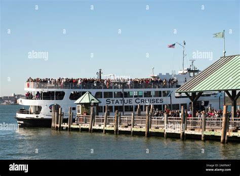 Ferry to Ellis Island Tour Boat Filled with Tourists Arrives at Dock at ...