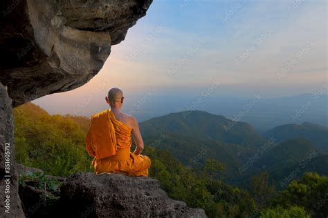 Buddhist monk in meditation Under the big stones in nature on high mountain. Stock Photo | Adobe ...