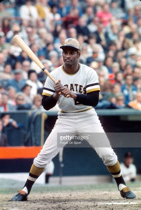 Outfielders Roberto Clemente' #21 of the Pittsburgh Pirates bats ...