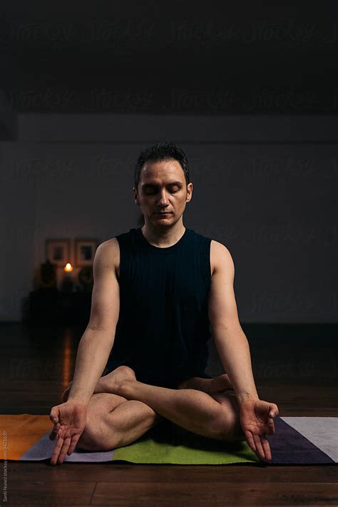 "Man Meditating In Yoga Pose" by Stocksy Contributor "Santi Nuñez" - Stocksy