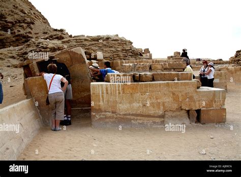 People looking at replica statue of Zoser in Serdab buildings of Zoser ...