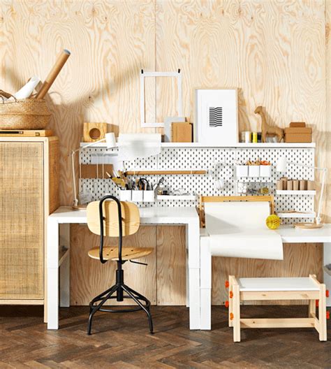 a white desk and chair in a room with wood paneling on the wall behind it