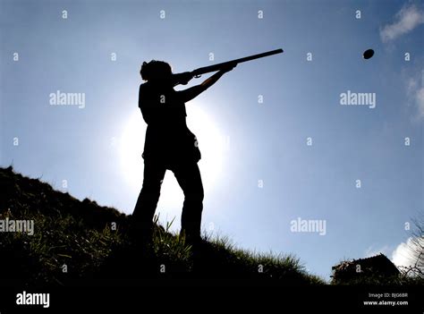 generic silhouette of a female in action shooting clay pigeons with a shotgun Stock Photo - Alamy