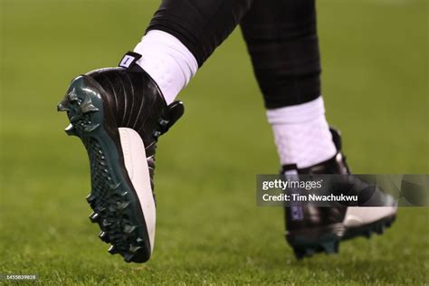 The cleats of Jalen Hurts of the Philadelphia Eagles are seen against ...