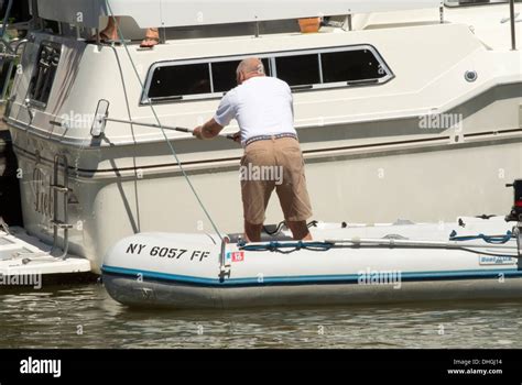 Man cleaning cabin cruiser Stock Photo - Alamy