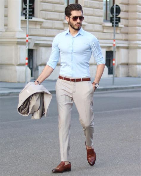 Man wearing tan colored #suit with blue shirt and brown belt/shoe to match. Wearing Ray ban s ...