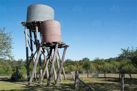 Image of Old farm water tanks leaning - Austockphoto