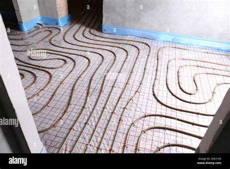 Installation of underfloor heating system in building Stock Photo - Alamy