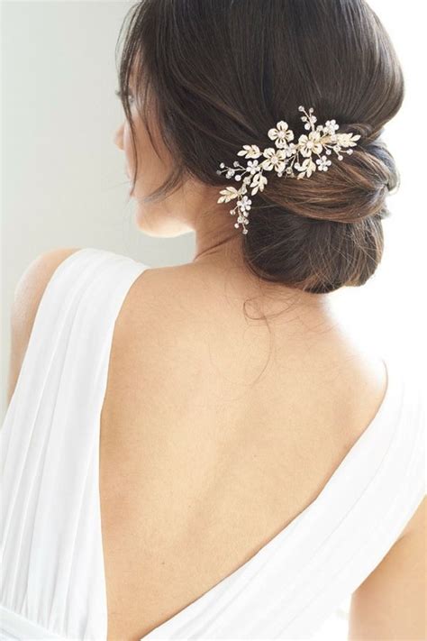 Wedding hair comb features a delicate floral side sweep of crystals and rhinestones that cascade ...