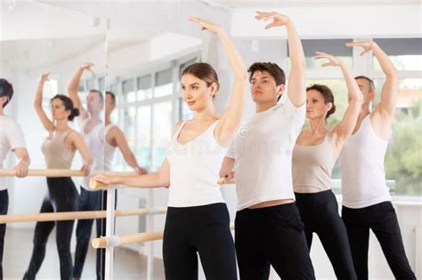 Group of Dancers Doing Batman Tandu Jete at Barre Stock Image - Image of flexible, exercising ...