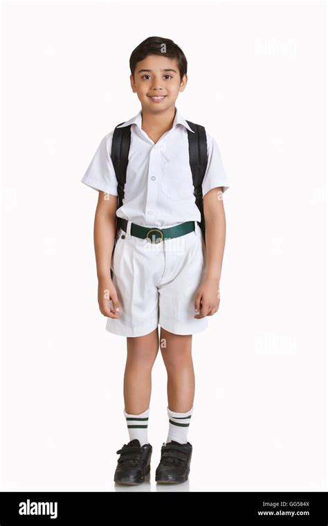 Full length portrait of boy wearing school uniform over white background Stock Photo - Alamy