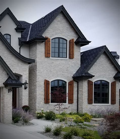 Exterior stone facade french country style stone clad home masonry ...