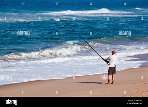 DURBAN, SOUTH AFRICA - JULY 2, 2014: Unknown fisherman on Blue Lagoon ...