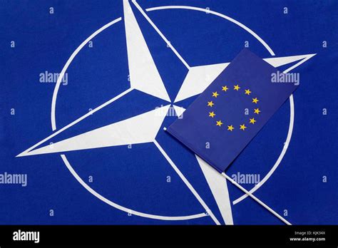 ILLUSTRATION - A small EU flag lies on top of the NATO symbol, 23.02. ...