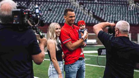 Desmond Ridder and his wife Claire Cornett with their daughter